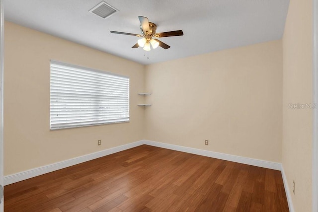 empty room featuring hardwood / wood-style floors and ceiling fan