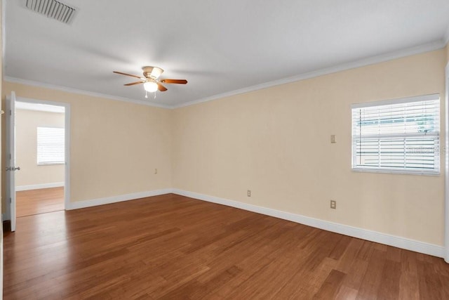 spare room with hardwood / wood-style floors, ornamental molding, and ceiling fan