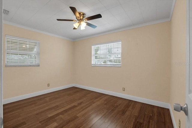 empty room with crown molding, dark hardwood / wood-style floors, and ceiling fan