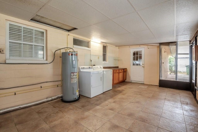 laundry area featuring cabinets, electric water heater, and washing machine and dryer