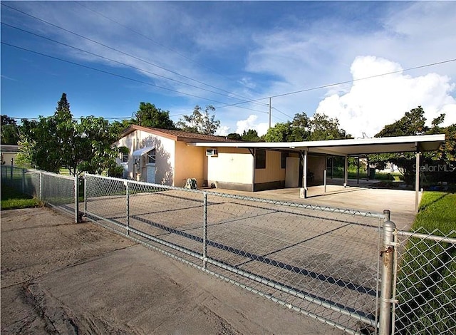 view of front facade with fence and an attached carport