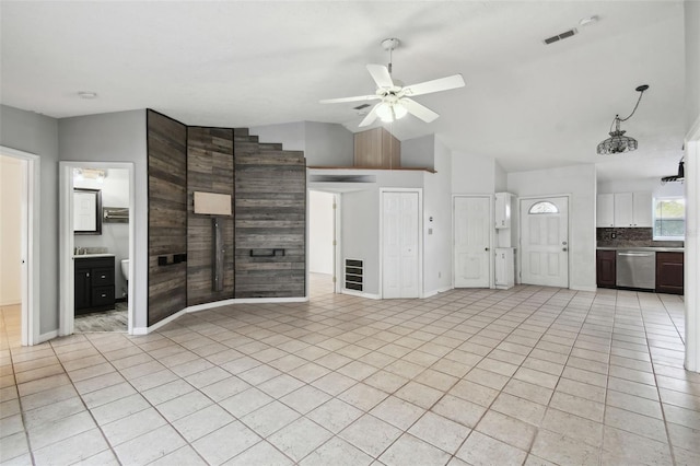 unfurnished living room with lofted ceiling, light tile patterned floors, and ceiling fan