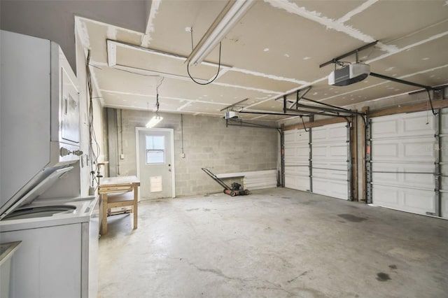 garage featuring stacked washer and clothes dryer and a garage door opener