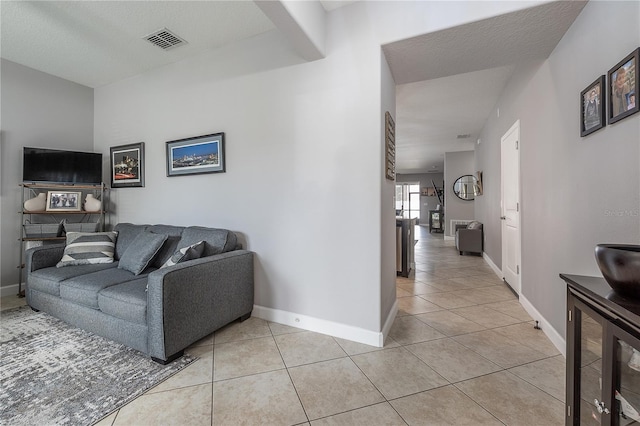 living room with light tile patterned floors and a textured ceiling