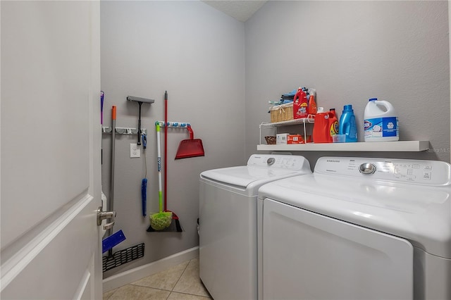 washroom with light tile patterned flooring and washer and clothes dryer