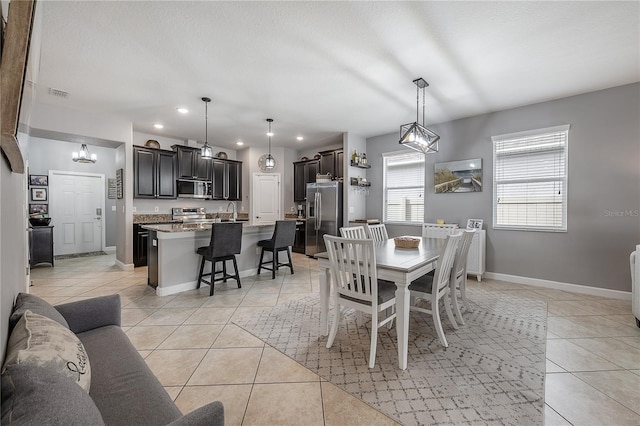 dining space with light tile patterned flooring and sink