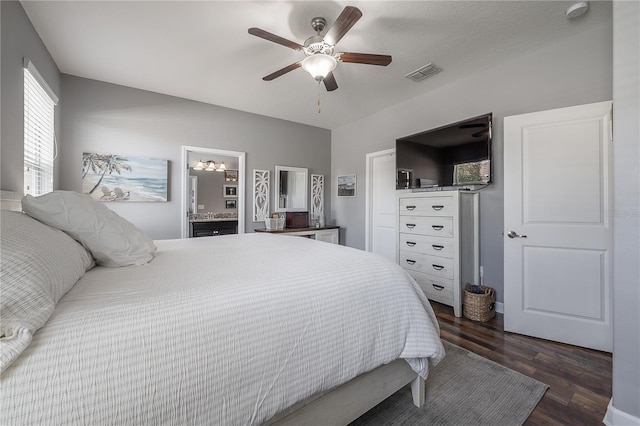 bedroom with ceiling fan, dark hardwood / wood-style floors, and ensuite bath