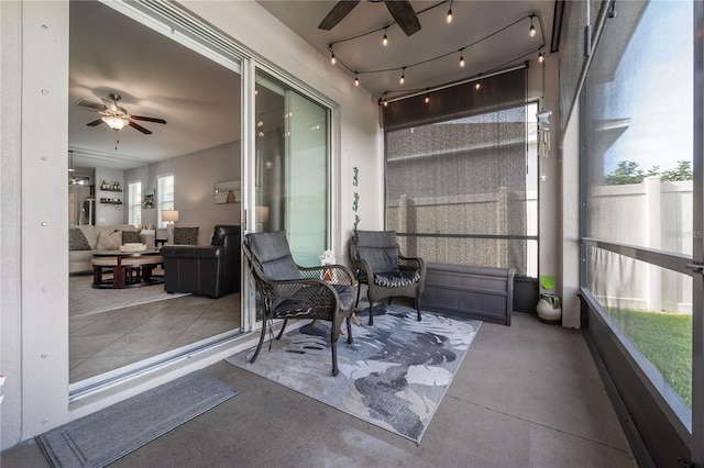 sunroom / solarium featuring ceiling fan