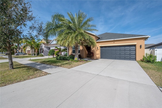 view of front of home featuring a garage and a front lawn