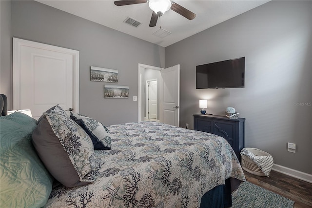 bedroom with dark hardwood / wood-style flooring and ceiling fan