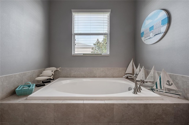 bathroom with a relaxing tiled tub