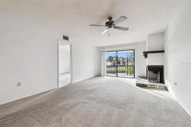 unfurnished living room featuring ceiling fan, carpet floors, and a textured ceiling