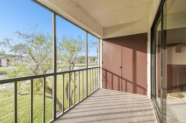 unfurnished sunroom with a water view