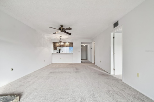 unfurnished living room with ceiling fan, light carpet, and a textured ceiling