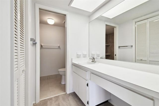 bathroom with vanity, tile patterned floors, and toilet