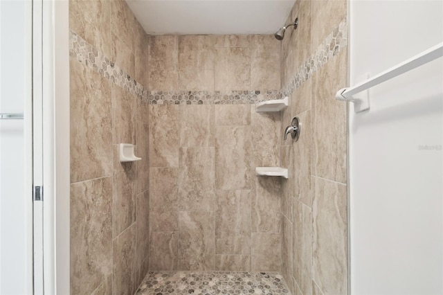 bathroom with a tile shower