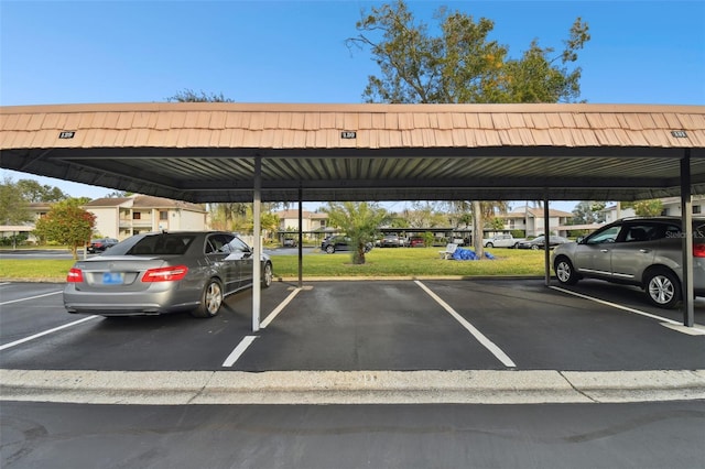 view of vehicle parking featuring a carport and a yard