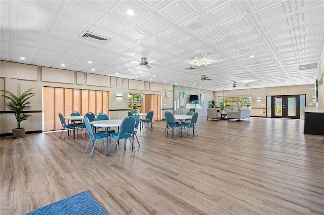 dining area with wood-type flooring and french doors