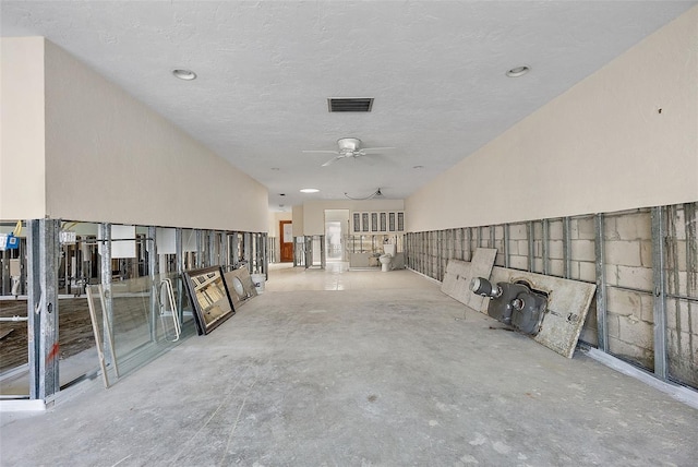 hall featuring a textured ceiling