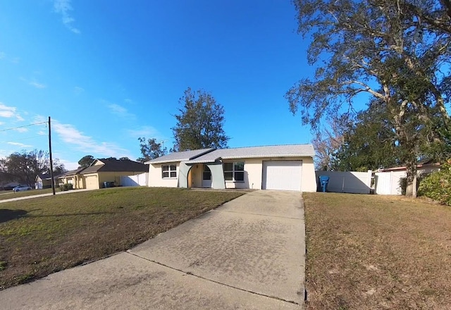 single story home with a garage and a front lawn