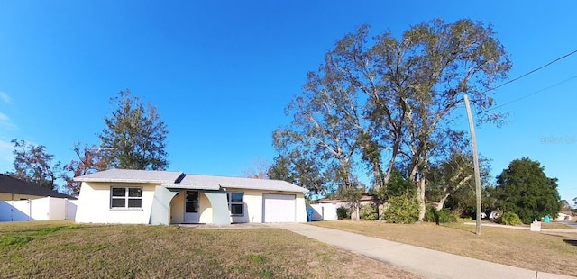 view of front of house with a garage and a front yard