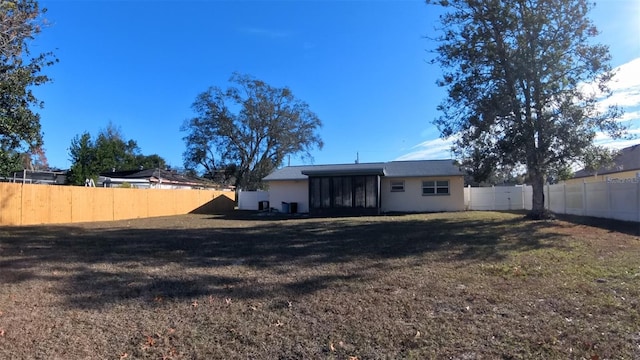 back of property featuring a lawn