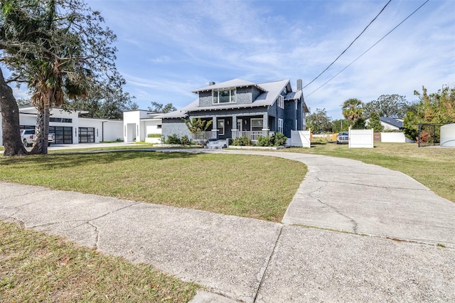 view of front of house featuring a garage, a porch, and a front yard