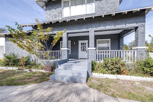 property entrance featuring covered porch