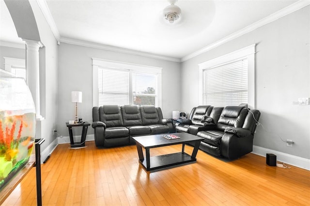 living room featuring ceiling fan, wood-type flooring, ornamental molding, and ornate columns