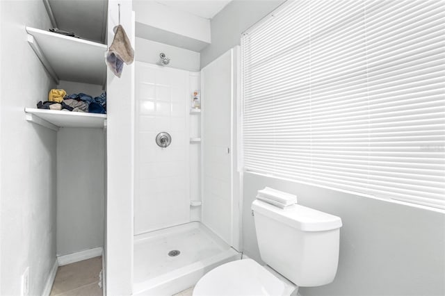 bathroom with toilet and a shower