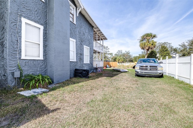 view of yard with a balcony