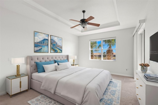 bedroom with a wall mounted air conditioner, light colored carpet, ceiling fan, and a tray ceiling