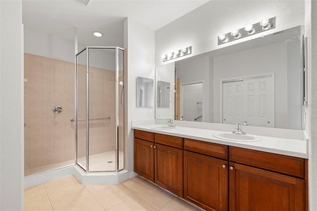 bathroom featuring tile patterned flooring, vanity, and walk in shower