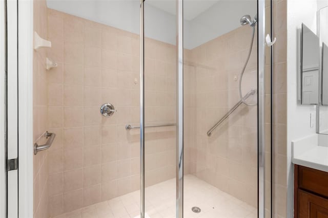 bathroom featuring vanity and a shower with door