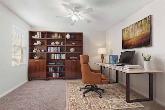 home office featuring light carpet and ceiling fan