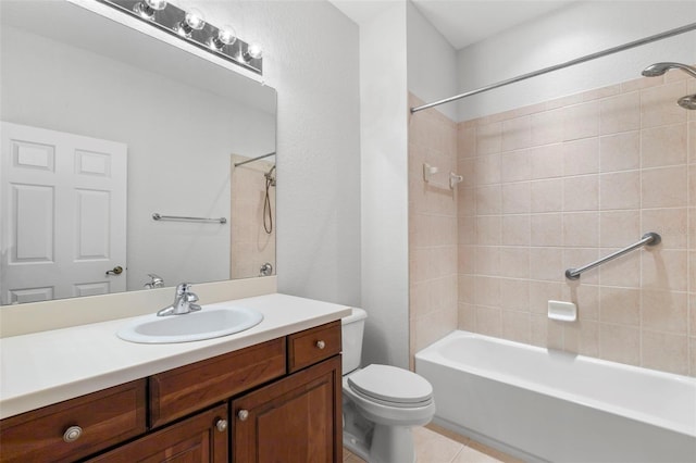 full bathroom with vanity, tiled shower / bath, tile patterned floors, and toilet