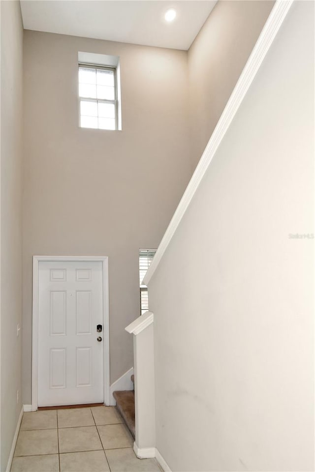 tiled foyer with a high ceiling