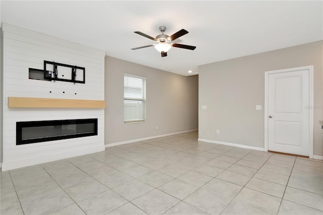 unfurnished living room featuring light tile patterned floors and ceiling fan