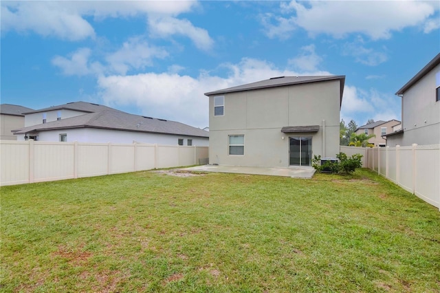 rear view of property featuring a patio area and a lawn