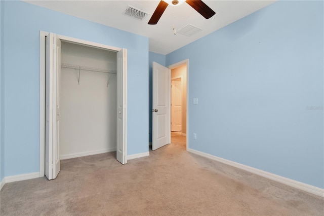 unfurnished bedroom featuring a closet, visible vents, a ceiling fan, light carpet, and baseboards