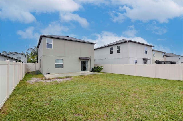 rear view of house featuring a patio area, a fenced backyard, stucco siding, and a yard