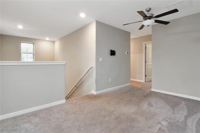 unfurnished room featuring recessed lighting, light carpet, and baseboards