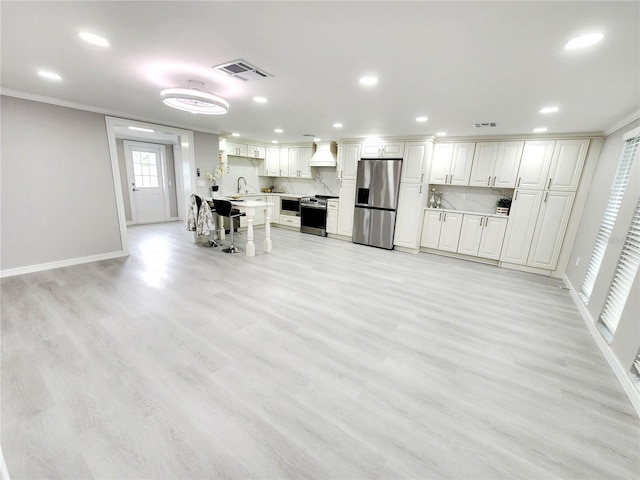 kitchen featuring visible vents, a sink, light countertops, appliances with stainless steel finishes, and backsplash