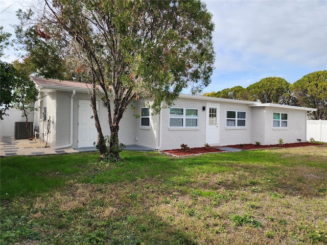 back of property featuring central AC unit and a lawn