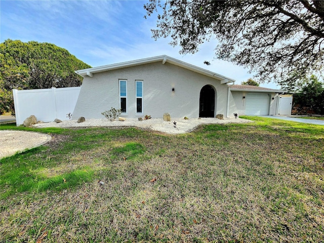 view of front of house featuring a garage and a front lawn