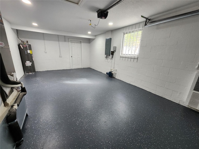 garage featuring electric panel, concrete block wall, a garage door opener, and water heater