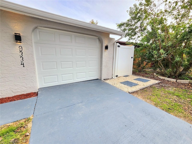 garage with concrete driveway