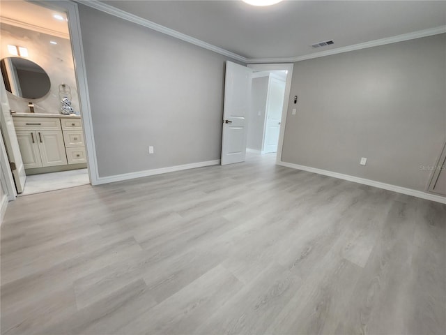 unfurnished bedroom featuring crown molding, light wood-style flooring, baseboards, and visible vents