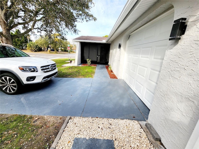 view of property exterior featuring a garage, driveway, and stucco siding