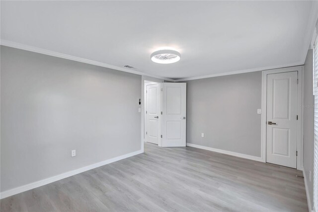 9334 Ledgestone Ln, Port Richey, FL 34668 - empty room featuring crown molding, wood finished floors, baseboards, and visible vents